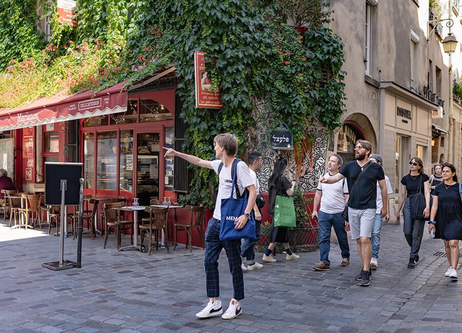 Guide pointing something out on the Marais tour