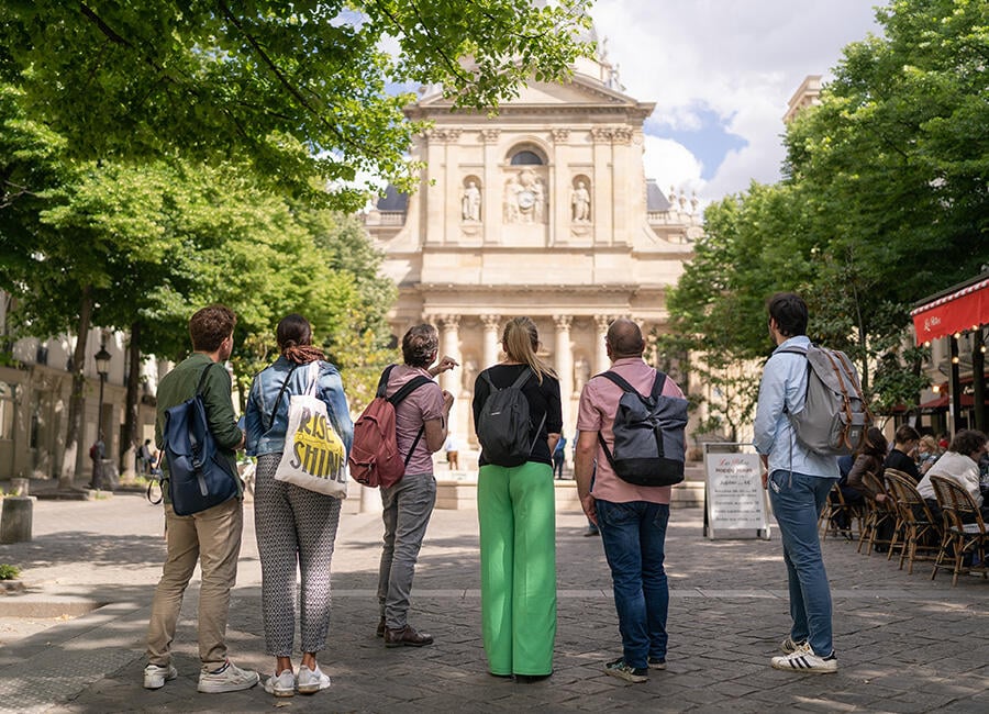 A group tour looking at a building in the Latin Quarter