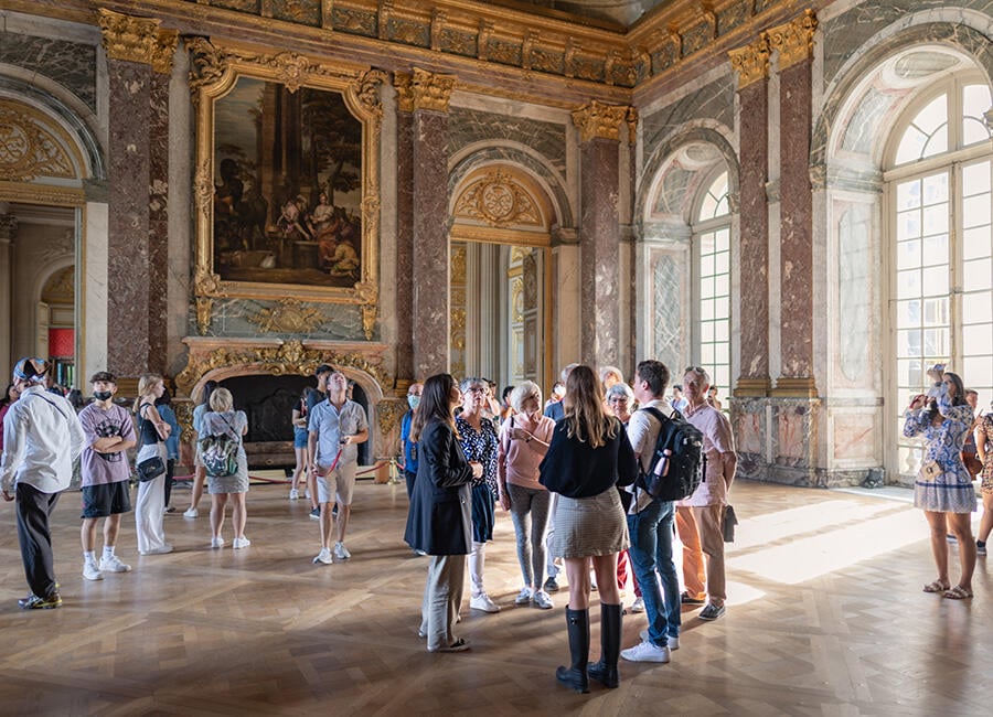 People standing inside of Versailles
